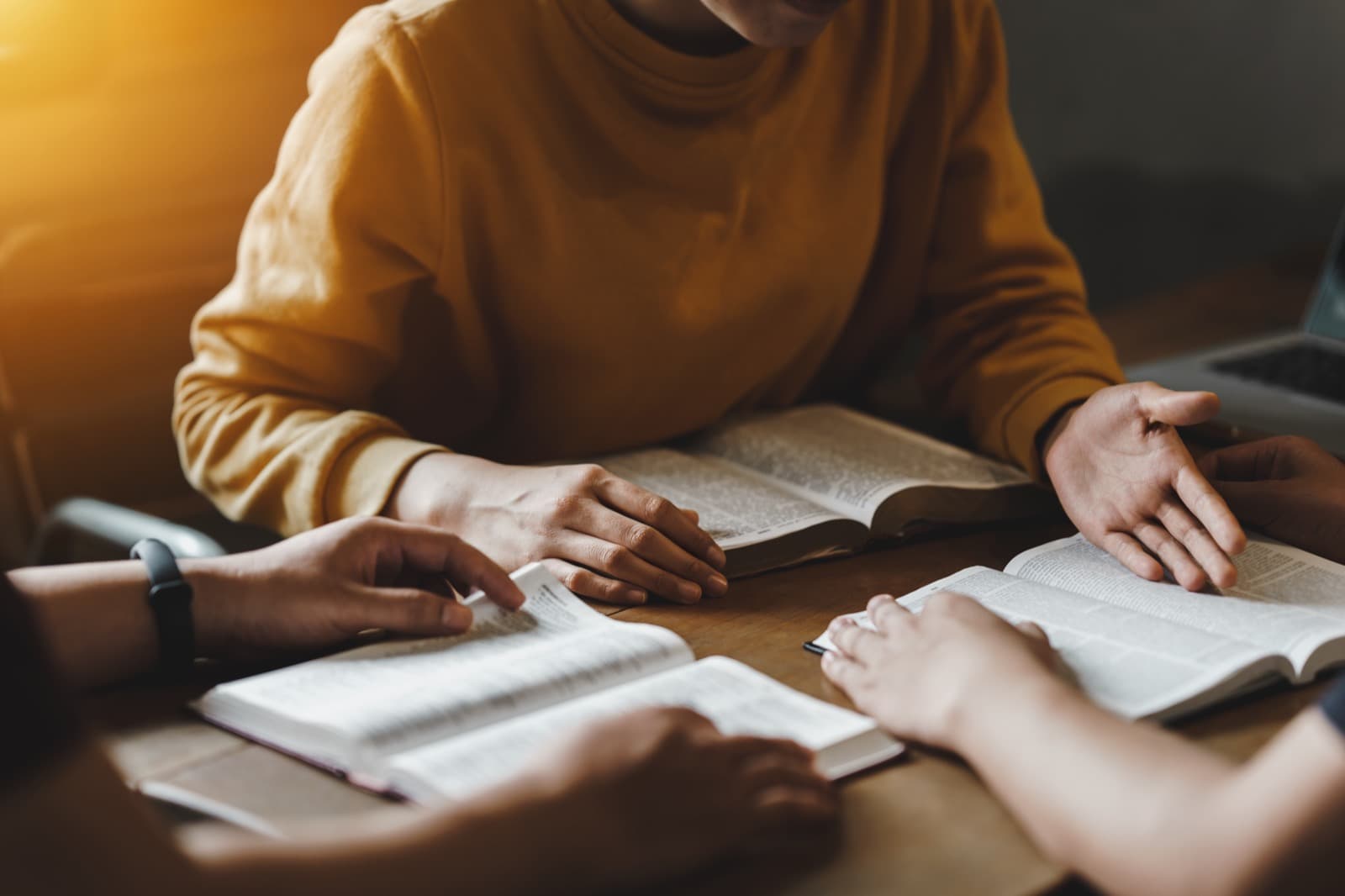 A small group reading and discussing the Bible together around a table