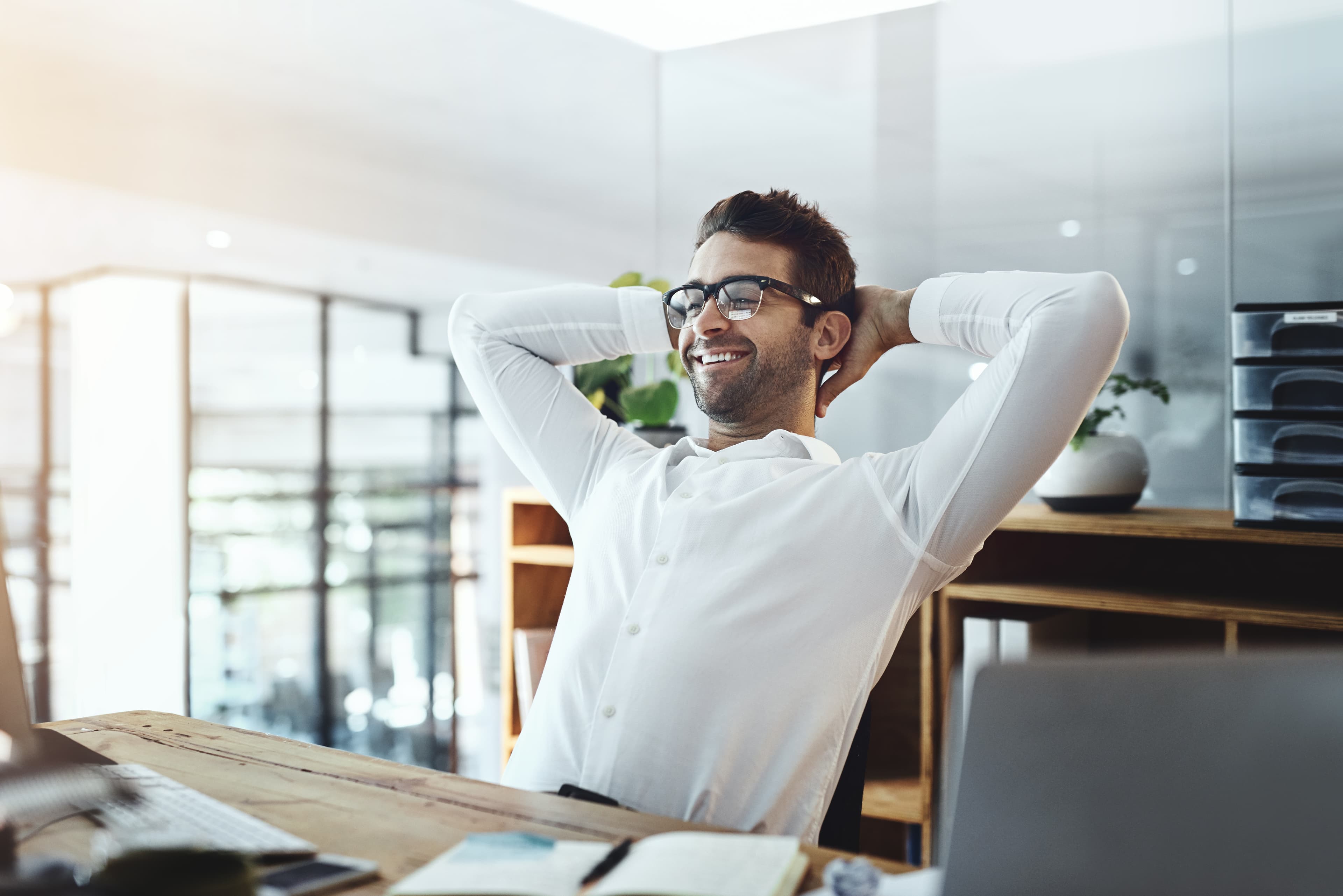 A pastor leaning back at his desk, relaxed and satisfied